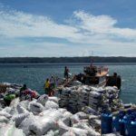 Copra piles at Mabila port, Balut Island
